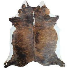 a brown and white cowhide rug on a white background, with the skin showing