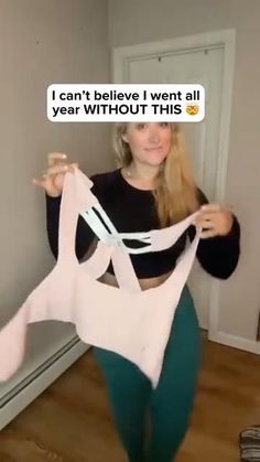 a woman is holding up a bra in front of her face and the caption says i can't believe i went all year without this