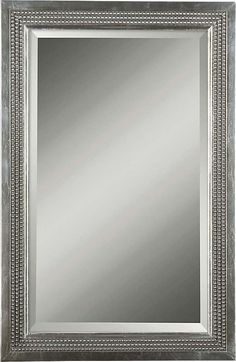 a silver framed mirror with beaded trim around the edges and an ornate border on the edge