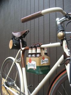 a bicycle with beer bottles strapped to the handlebars