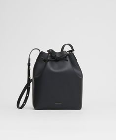 !!!Description---Our iconic Bucket Bag blends form and function, fitting an iPad, water bottle, and makeup bag. Crafted from Italian vegetable tanned leather, it ages beautifully over time, with an adjustable strap and cinch closure. Mansur Gavriel Bucket Bag, Mansur Gavriel Bag, Black Bucket Bag, Black Ballerina, Italian Bags, Black Bucket, Luxury Crossbody, Mansur Gavriel, Classic Leather