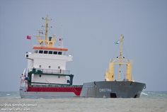 two large boats in the water near each other