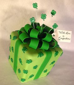 a green wrapped present with shamrocks on it