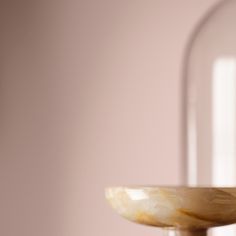 a marble bowl sitting on top of a wooden table