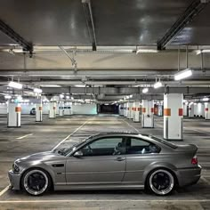 a silver car parked in a parking garage