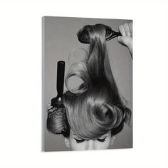 a black and white photo of a woman's hair being styled by a brush