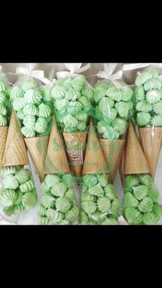 green and white cupcakes in cones on display