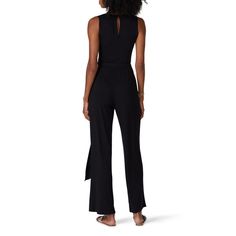 Black knit (94% Polyester 6% Spandex). Jumpsuit. Sleeveless. V-neckline. Twist front tie closure. 58" from shoulder to hemline. Made in the USA. Summer Stretch Jumpsuits And Rompers With Tie Waist, Stretch Elastane Jumpsuits And Rompers For Summer, Chic V-neck Elastane Jumpsuits And Rompers, Fitted Sleeveless Bodysuit With Tie Back, Chic Sleeveless Bodysuit With Tie Back, Chic Fitted Bottoms With Tie Back, Chic Spring Jumpsuits And Rompers, Chic Elastane Jumpsuits And Rompers For Spring, Sleeveless Stretch Bodysuit With Tie Back