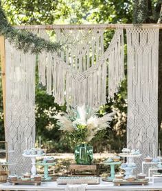 a table topped with lots of white flowers and tassels