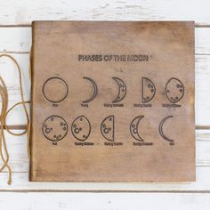 the phases of the moon on a brown book