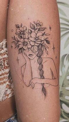 a woman with flowers in her hair is shown on the thigh and behind her arm