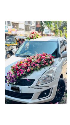 a white car with flowers on the hood