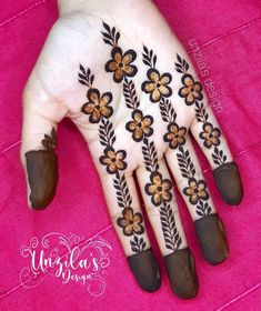 the hand is decorated with flowers and leaves on it's fingers, which are adorned with