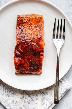 a piece of salmon on a plate with a fork