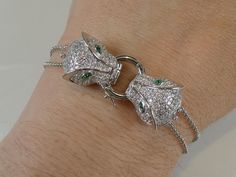 A fine solid silver art deco designed double panther cat head bracelet, the two heads joined with a central silver ring and each has a belcher chain either side to from the bracelet, the heads fully encrusted with clear cubic zirconia's that sparkle like real diamonds when worn .each  head measure 1.4cm x 1.8cm, measures 7.1/2 inches long inc extender so can be worn looser or tighter on wrist. Formal Silver Jewelry With Diamond Eyes, Panther Cat, Two Heads, Silver Art, Art Deco Design, Real Diamonds, Link Bracelets, Panther, Art Deco Fashion