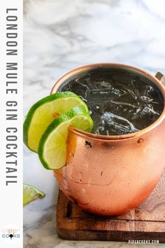 a copper cup filled with liquid and lime wedges