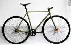 a green bike with black spokes is shown against a white background