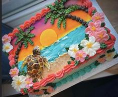 there is a cake decorated with flowers and a turtle