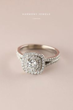 a diamond ring with two rows of diamonds on the band and an oval shaped center stone