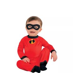 a little boy wearing a red and black costume