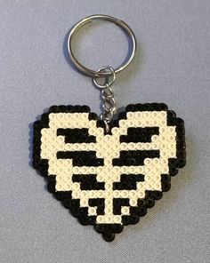 a black and white pixel heart shaped keychain