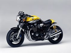 a yellow and black motorcycle is shown in this image