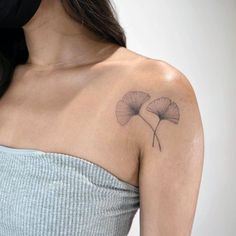 a woman with a tattoo on her shoulder