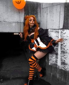 a woman dressed up as a witch with orange hair