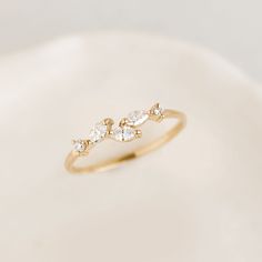 a gold ring with three diamonds on it