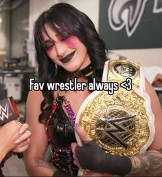 a woman holding a wrestling belt with the words fav wrestler always 3