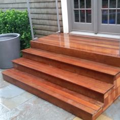 wooden steps leading to the front door of a house