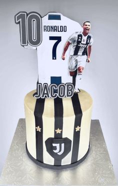 a birthday cake with a photo of ronaldo and his jersey on top is decorated in black and white stripes