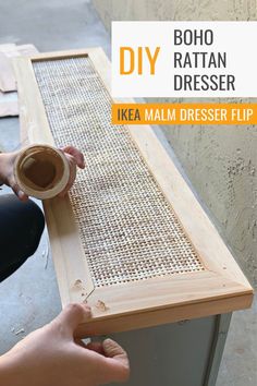 a person is holding a cup and making a diy dresser