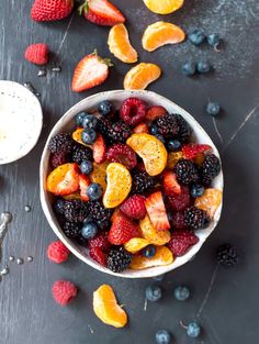 a bowl filled with fruit sitting on top of a table