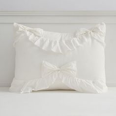 a white pillow with a bow on it