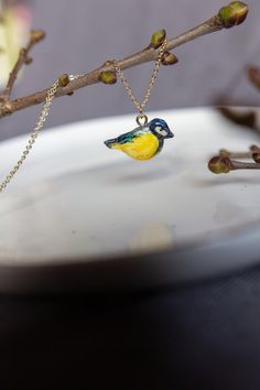 Option 1 - pendant in the gift box; Option 2 - pendant + 18K gold plated metal chain in a gift box. Small and cute great tit pendant already packed as a gift. Extremely lovely and cool jewelry necklace design. Blue, yellow bird pendant is lightweight and so comfortable to wear. Perfect gift for bird lovers/ watchers/ gardeners: woman, kids, girls, teens, hipsters, ladies, artists. Chain  - high quality 18K gold plated copper metal chain, minimum length - 44cm (17.3 in), max - 50cm (19.5 in). Chain thickness - 1.4mm (0.05 in). MANDMADE Homemade in our small liiber design art studio. Pendants made of polymer clay, hand painted with colors and finished with varnish, waterproof. 100% handmade. Please note that each peace is handmade, therefore there will be some slight variations in size and c Gold Bird-shaped Jewelry With Bird Design, Bird-shaped Bird-design Necklace For Gifts, Bird Pendant Necklace For Gift, Bird Design Necklace As A Gift, Bird Design Necklace Perfect For Gifts, Bird Design Pendant Necklace As A Gift, Bird Design Pendant Necklace Gift, Bird Design Pendant Necklace As Gift, Bird Design Necklace For Gift