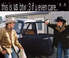 two men standing next to each other near an old truck and one has his hand on the door