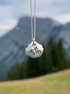 Remember your personalized journey through loss or challenging circumstances with a solid silver nugget engraved with a beautiful nature symbol. Hold your loss and link to nature close to your heart. Chose the symbol that resonates with you the most: -Daisy -Dandelion poof -Dragonfly -Footprints -Forget-me-not  -Mushroom -Mountains -Trees -Sand Dollars *1-2 Letters or Numbers able to be engraved on the back.  Each of these pendants is 100% unique. Made from high quality recycled silver, they are Personalized Silver Nature-inspired Jewelry, Etched Sterling Silver Jewelry As Gift, Spiritual Stamped Silver Jewelry, Sterling Silver Etched Jewelry As Gift, Sterling Silver Etched Jewelry For Gifts, Nature-inspired Stamped Jewelry For Everyday, Everyday Symbolic Hand Stamped Jewelry, Everyday Silver Nature-inspired Jewelry, Silver Engraved Nature-inspired Necklace