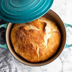 a loaf of bread sitting in a blue pot