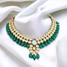 Rani green Drop Kundan back Meenakari Necklace set. Expertly crafted with Rani green Kundan and Meenakari work, this necklace set adds a touch of elegance to any outfit. Its intricate design and vibrant color make it a standout piece. Perfect for special occasions or as a statement accessory. Green Emerald Bridal Necklace Gift, Heavy Green Jewelry For Gifts, Traditional Green Jewelry For Gift, Heavy Green Jewelry As A Gift, Green Emerald Jewelry For Festivals, Kundan Green Jewelry Gift, Green Kundan Jewelry Gift, Green Kundan Jewelry For Gift, Green Kundan Jewelry As A Gift