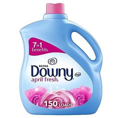 a bottle of downy liquid with pink roses on the front and blue top, sitting on