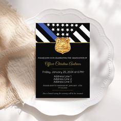 a police officer graduation party is shown on a plate with white cloth and napkins