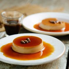 two white plates topped with dessert on top of a wooden table