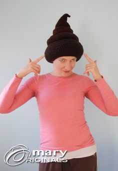 a woman is wearing a knitted hat and making the peace sign with her hands