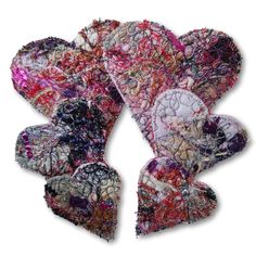 several pieces of fabric are arranged in the shape of hearts