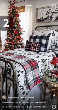 a bedroom decorated for christmas with red, black and white plaid bedding in the foreground