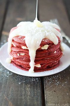 a stack of pancakes with icing on a plate