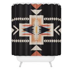 a black shower curtain with an orange and white southwestern design on the front, featuring arrows