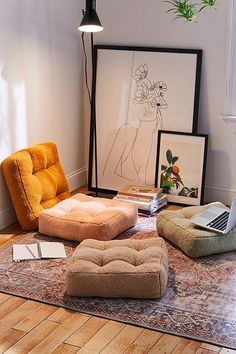 a living room filled with furniture and art on the floor next to a laptop computer