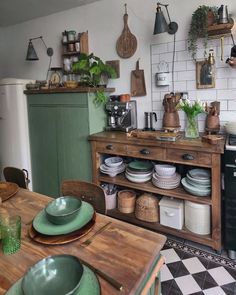 a kitchen filled with lots of pots and pans next to a stove top oven